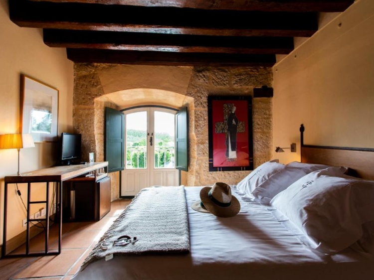 Rustic bedroom, Stone walls, Wooden beams, Cozy bed, Hotel room